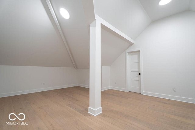 395 Breakwater Dr, Fishers, IN 46037 - bonus room featuring baseboards, lofted ceiling, and light wood-style floors
