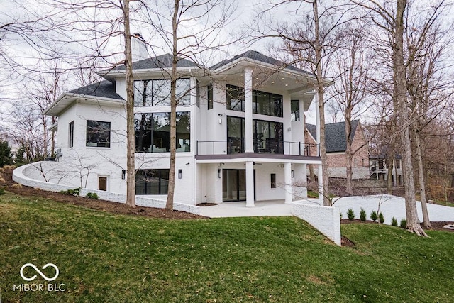 395 Breakwater Dr, Fishers, IN 46037 - back of property with a balcony, a patio area, and a lawn