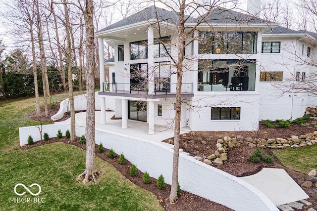 395 Breakwater Dr, Fishers, IN 46037 - view of side of property featuring a balcony, a lawn, and stucco siding