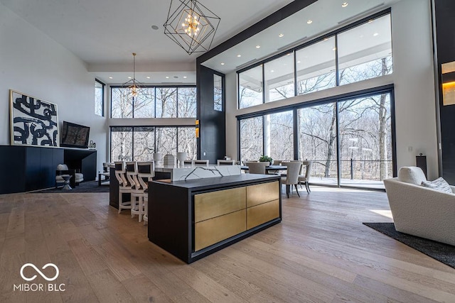 395 Breakwater Dr, Fishers, IN 46037 - living room featuring wood finished floors, an inviting chandelier, and recessed lighting