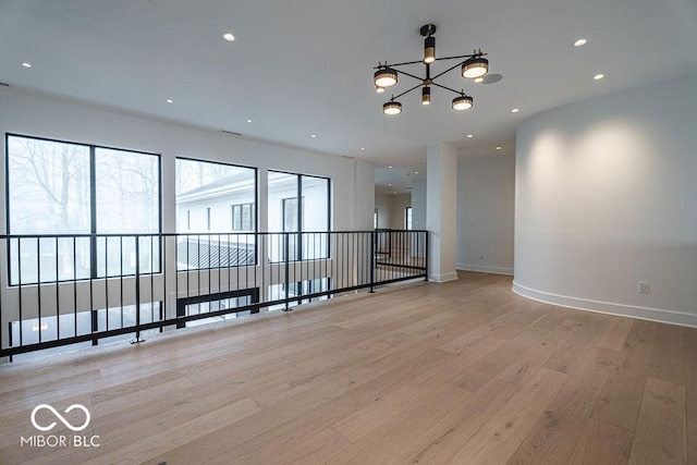 395 Breakwater Dr, Fishers, IN 46037 - empty room with an inviting chandelier, light wood-style flooring, baseboards, and recessed lighting
