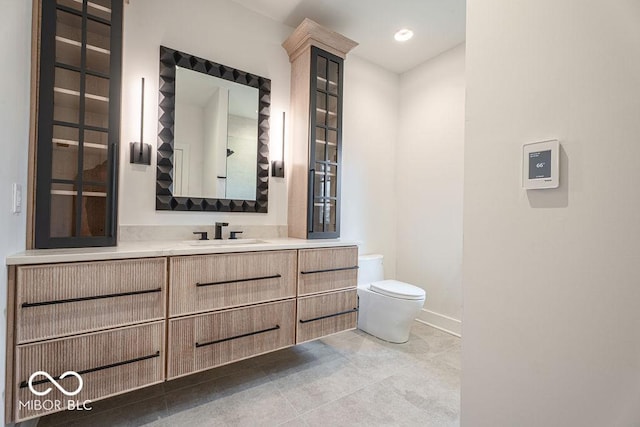 395 Breakwater Dr, Fishers, IN 46037 - bathroom with toilet, vanity, tile patterned flooring, baseboards, and recessed lighting