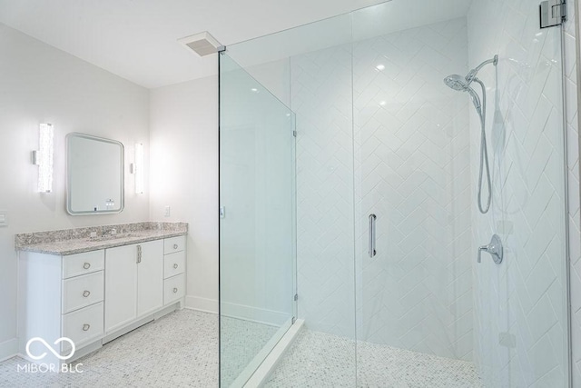 395 Breakwater Dr, Fishers, IN 46037 - bathroom featuring a shower stall, baseboards, speckled floor, and vanity