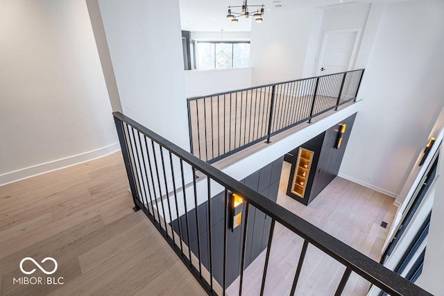 395 Breakwater Dr, Fishers, IN 46037 - stairs featuring baseboards, wood finished floors, and a notable chandelier