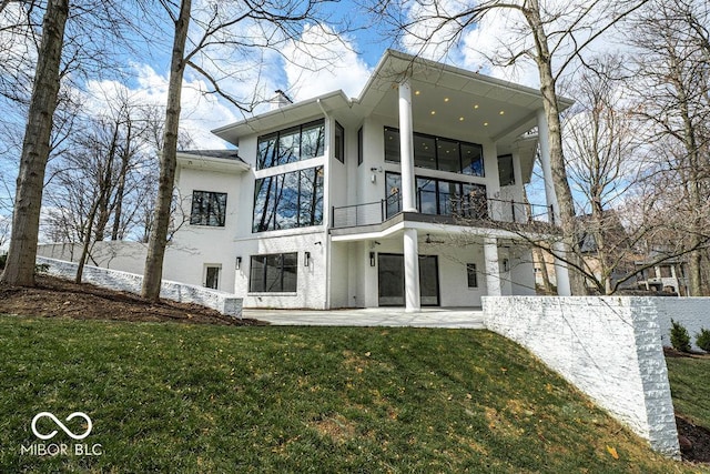 395 Breakwater Dr, Fishers, IN 46037 - rear view of property featuring a balcony, a yard, a patio, and stucco siding
