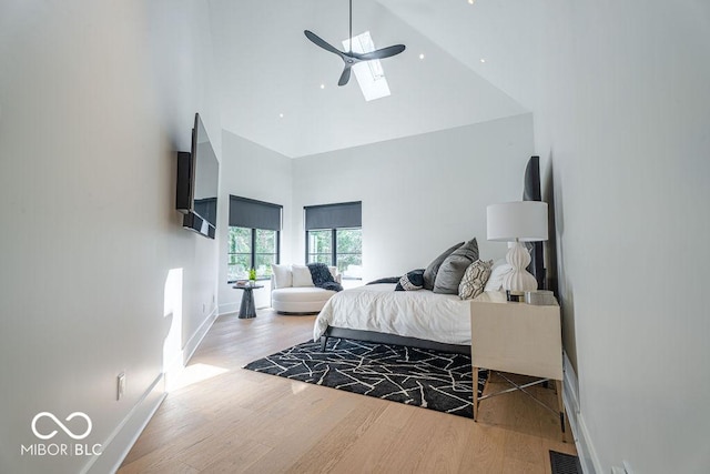395 Breakwater Dr, Fishers, IN 46037 - bedroom with baseboards, a high ceiling, a skylight, visible vents, and wood finished floors
