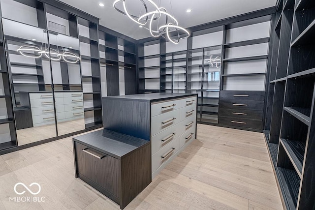 395 Breakwater Dr, Fishers, IN 46037 - spacious closet with a notable chandelier and light wood-type flooring