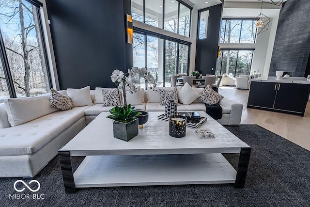 395 Breakwater Dr, Fishers, IN 46037 - living area featuring a high ceiling, wood finished floors, and an inviting chandelier