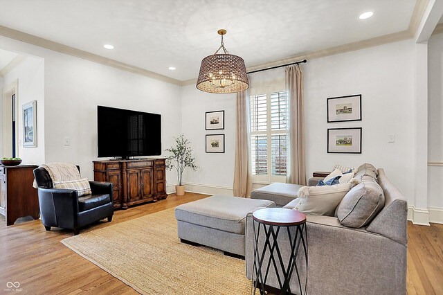 450 W Ash St, Zionsville, IN 46077 - living area with light wood-style flooring, crown molding, a notable chandelier, and baseboards