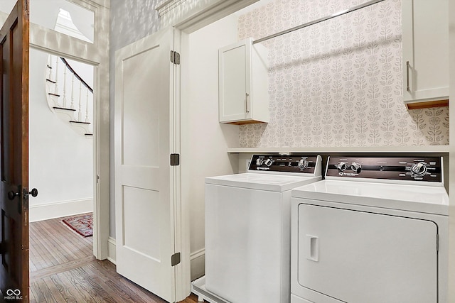 450 W Ash St, Zionsville, IN 46077 - clothes washing area with wood finished floors, washing machine and clothes dryer, and cabinet space