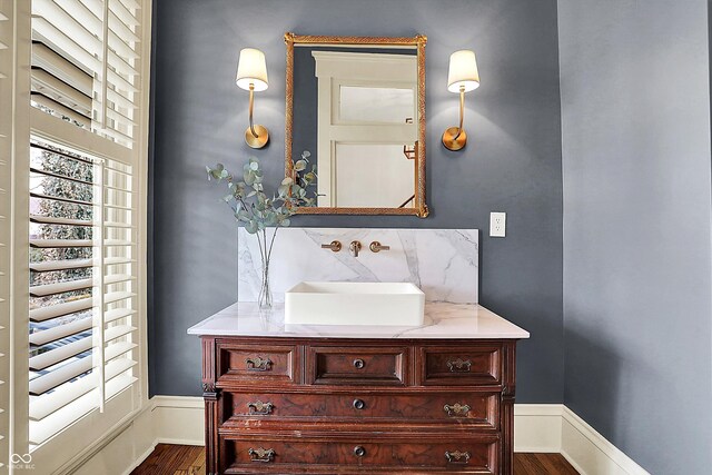 450 W Ash St, Zionsville, IN 46077 - bathroom featuring decorative backsplash, wood finished floors, and vanity
