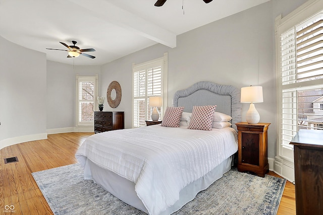 450 W Ash St, Zionsville, IN 46077 - bedroom featuring visible vents, baseboards, a ceiling fan, beam ceiling, and wood finished floors