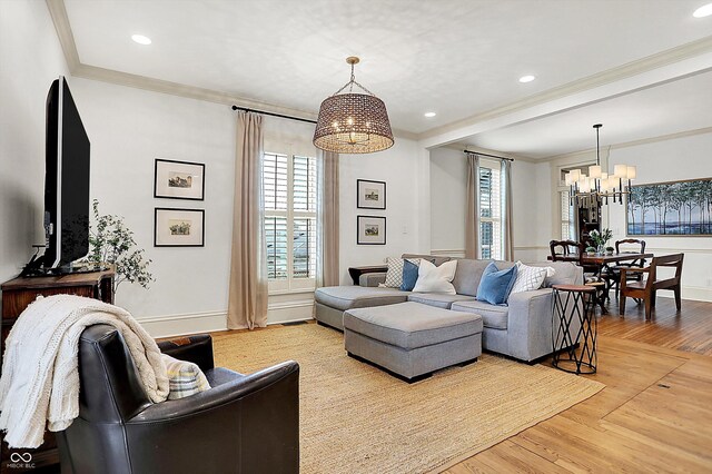 450 W Ash St, Zionsville, IN 46077 - living room featuring a wealth of natural light, light wood finished floors, and a notable chandelier