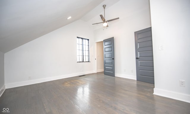 interior space featuring vaulted ceiling, dark wood-type flooring, baseboards, visible vents, and a ceiling fan