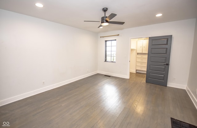 unfurnished bedroom featuring dark wood-style flooring, visible vents, baseboards, recessed lighting, and a spacious closet
