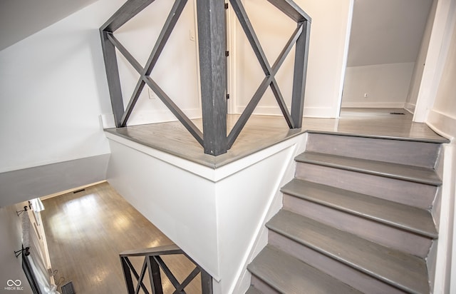 stairway featuring wood finished floors