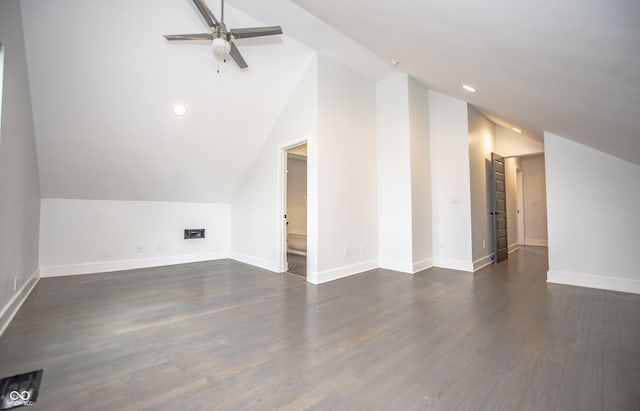 bonus room with a ceiling fan, baseboards, vaulted ceiling, and dark wood finished floors