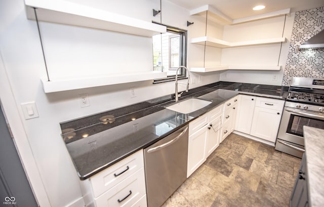 kitchen with white cabinetry, open shelves, stone finish floor, a sink, and appliances with stainless steel finishes
