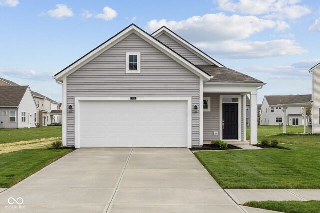 view of front facade featuring a front yard, driveway, and a garage