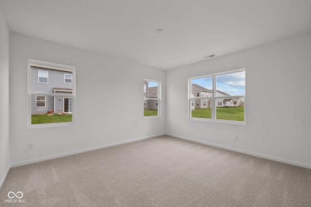 carpeted spare room with baseboards