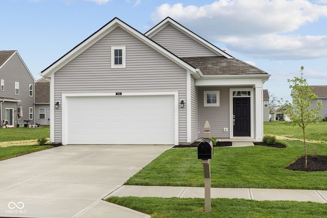 view of front of house with concrete driveway, a front lawn, and a garage