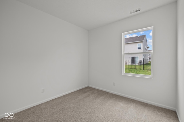 unfurnished room with carpet floors and baseboards