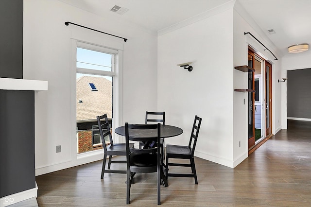 932 Broadway St # 15, Indianapolis, IN 46202 - dining room with visible vents, ornamental molding, baseboards, and wood finished floors