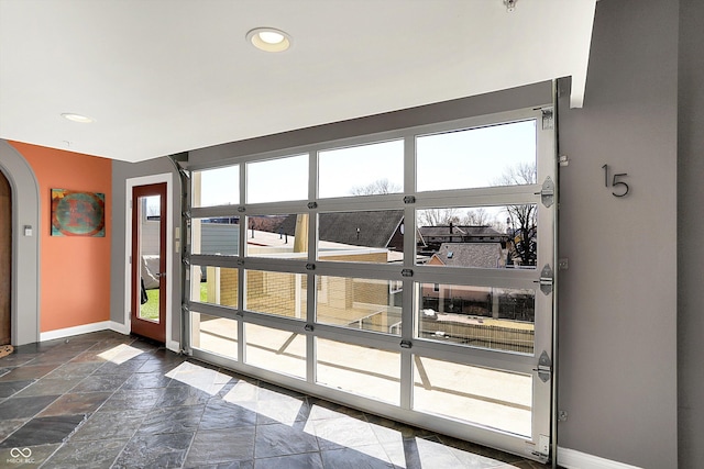 932 Broadway St # 15, Indianapolis, IN 46202 - doorway to outside featuring recessed lighting, baseboards, arched walkways, and stone tile floors