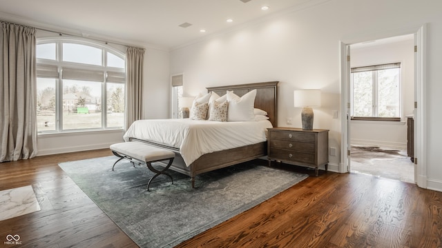 bedroom with multiple windows, crown molding, baseboards, dark wood-type flooring, and recessed lighting