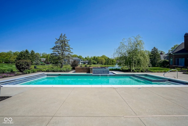 view of pool with a patio and a pool with connected hot tub
