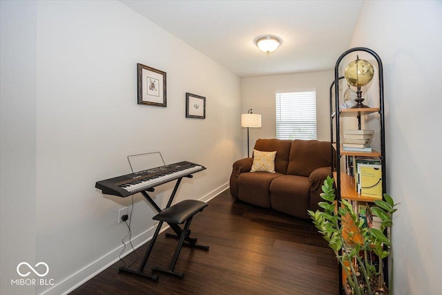 living area featuring wood finished floors and baseboards