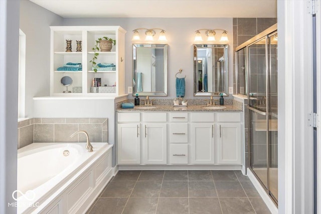 bathroom with a shower stall, double vanity, a bath, and tile patterned floors