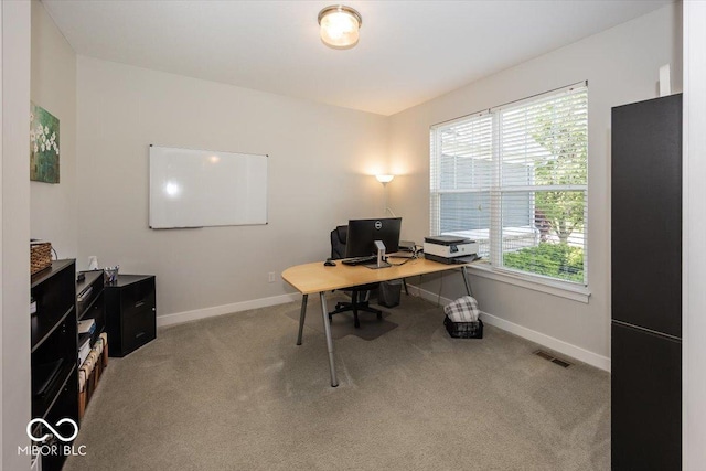 carpeted office space with baseboards