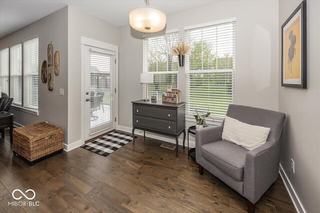 sitting room featuring hardwood / wood-style flooring and baseboards