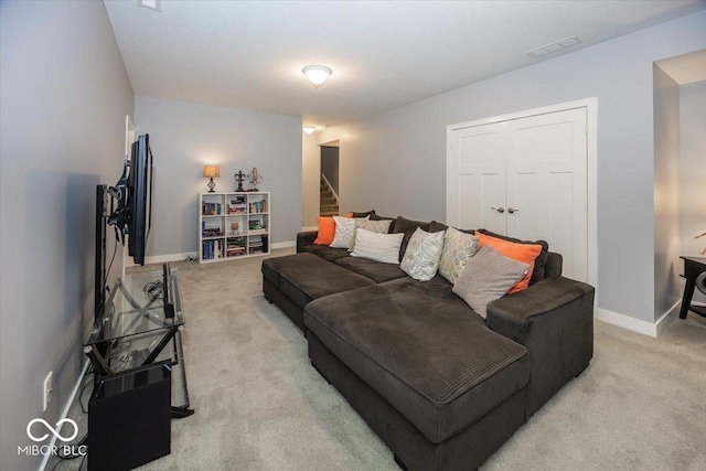 living room featuring light carpet, stairs, and baseboards