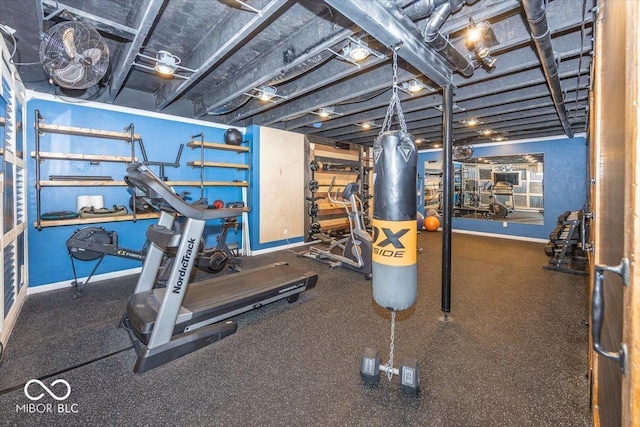 workout room featuring baseboards