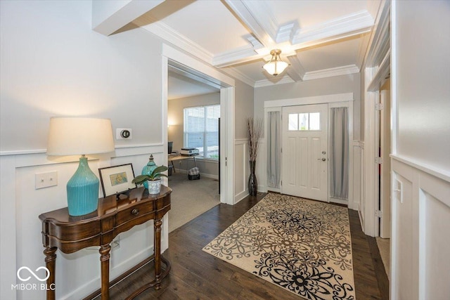 entrance foyer with ornamental molding, coffered ceiling, a wainscoted wall, healthy amount of natural light, and a decorative wall