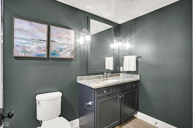 5120 Melbourne Pl, Zionsville, IN 46077 - half bathroom featuring vanity, toilet, baseboards, and wood finished floors