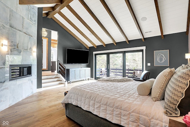 5120 Melbourne Pl, Zionsville, IN 46077 - bedroom featuring hardwood / wood-style flooring, a fireplace, wooden ceiling with exposed beams, high vaulted ceiling, and access to outside
