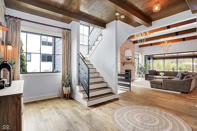 5120 Melbourne Pl, Zionsville, IN 46077 - foyer with stairs, light wood-style flooring, wooden ceiling with exposed beams, baseboards, and a chandelier
