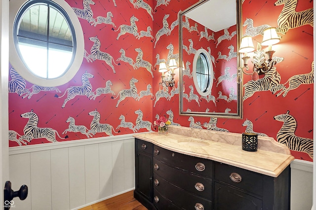 5120 Melbourne Pl, Zionsville, IN 46077 - bathroom featuring a wainscoted wall, vanity, wood finished floors, and wallpapered walls