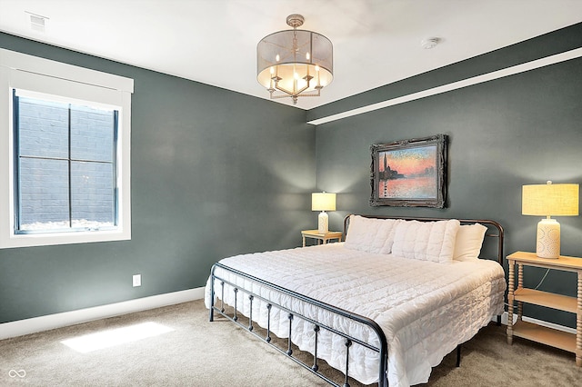 5120 Melbourne Pl, Zionsville, IN 46077 - carpeted bedroom featuring baseboards, multiple windows, and a chandelier