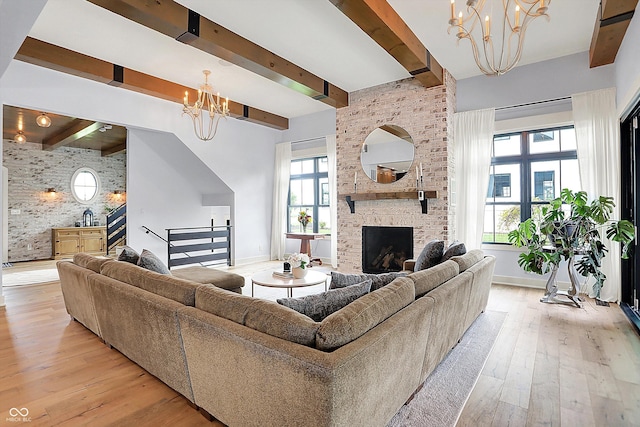 5120 Melbourne Pl, Zionsville, IN 46077 - living area featuring a chandelier, beamed ceiling, light wood-type flooring, baseboards, and a brick fireplace