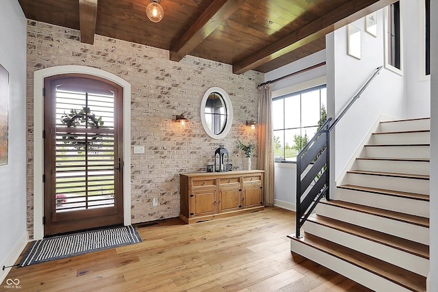 5120 Melbourne Pl, Zionsville, IN 46077 - foyer entrance with brick wall, wood ceiling with exposed beams, stairway, light wood-style floors, and baseboards
