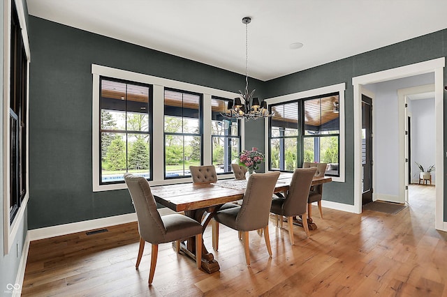 5120 Melbourne Pl, Zionsville, IN 46077 - dining area featuring a chandelier, light wood-type flooring, and baseboards