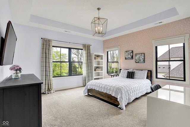 5120 Melbourne Pl, Zionsville, IN 46077 - bedroom featuring a tray ceiling, a chandelier, light carpet, and baseboards