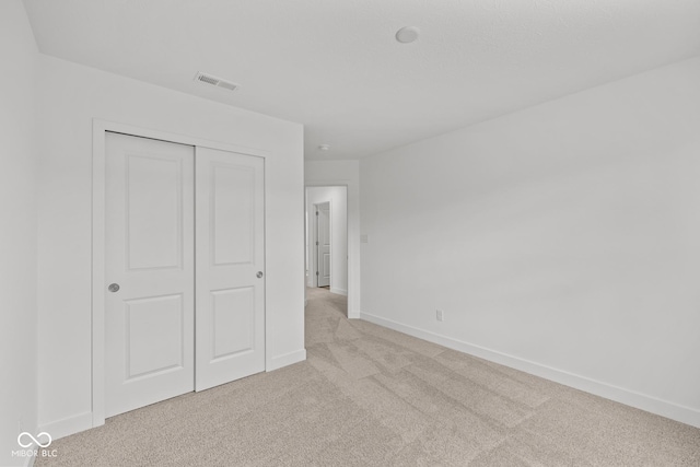3913 Highcrest Rd, Indianapolis, IN 46239 - unfurnished bedroom featuring light colored carpet, baseboards, and a closet