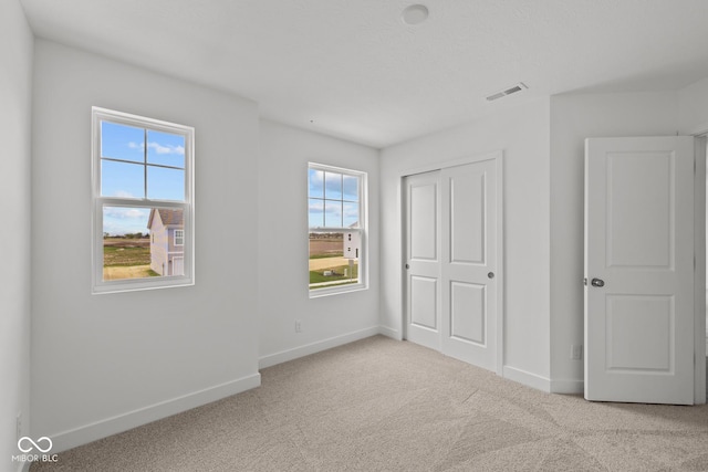 3913 Highcrest Rd, Indianapolis, IN 46239 - unfurnished bedroom featuring carpet floors, baseboards, and a closet