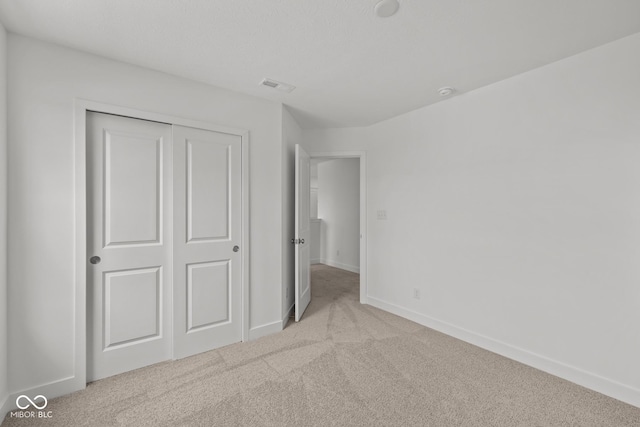 3913 Highcrest Rd, Indianapolis, IN 46239 - unfurnished bedroom with carpet flooring, a closet, and baseboards