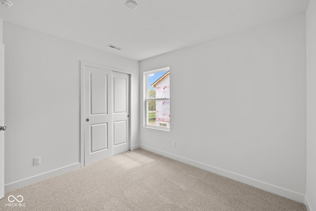 3913 Highcrest Rd, Indianapolis, IN 46239 - unfurnished bedroom with carpet floors, baseboards, and a closet